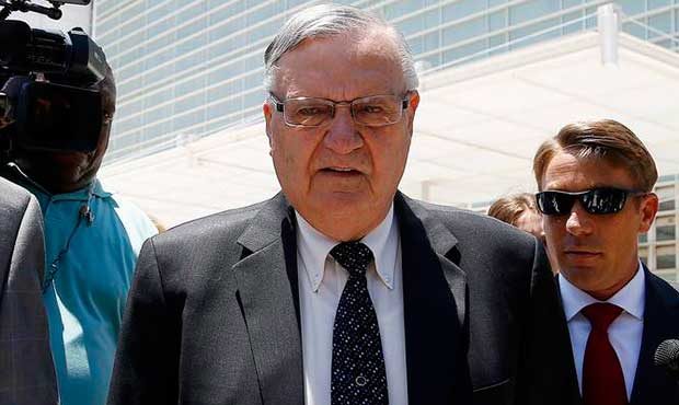 Former Maricopa County Sheriff Joe Arpaio, second from right, leaves U.S. District Court on the fir...
