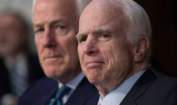 Sen. John McCain, R-Ariz., right, with Sen. John Cornyn, R-Texas, listens as Attorney General Jeff ...