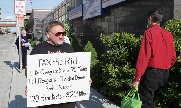 In this April 17, 2012, photo, James Hodgkinson of Belleville protests outside of the United States Post Office in Downtown Belleville, Ill. A government official says the suspect in the Virginia shooting that injured Rep. Steve Scalise and several others has been identified Hodgkinson. (Derik Holtmann/Belleville News-Democrat, via AP)