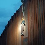 Woman hanging on fence 1
