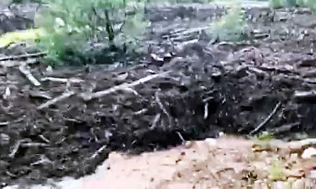 This Saturday, July 15, 2017 image from video provided by Scott Muller shows the flash flood just u...