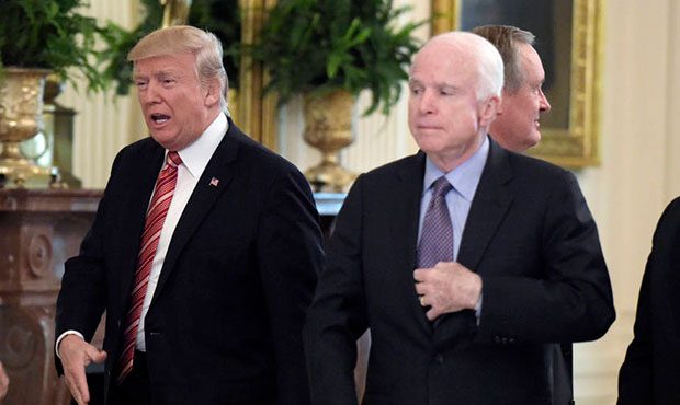President Donald Trump, second from left, reached out to shake hands with Sen. Todd Young, R-Ind., ...