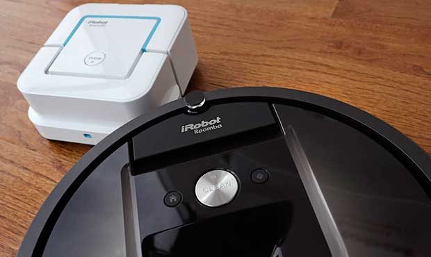 In this Thursday, Aug. 25, 2016, photo, an iRobot Braava Jet floor cleaner, top, and Roomba vacuum ...