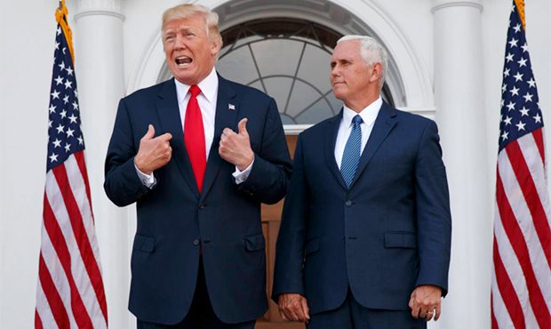 In this Aug. 10, 2017, photo, President Donald Trump, accompanied by Vice President Mike Pence, spe...