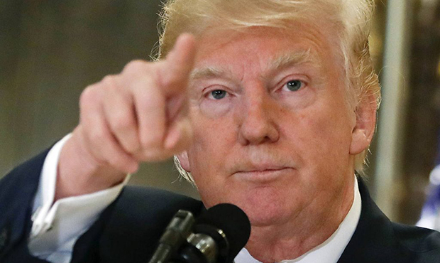 In this Aug. 15, 2017, photo, President Donald Trump points to members of the media as he answers q...