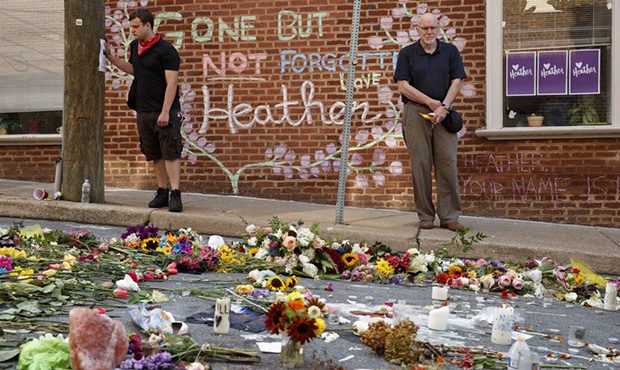 Jason Charter, left, of Washington, stands at a memorial, Wednesday, Aug. 16, 2017, in Charlottesvi...
