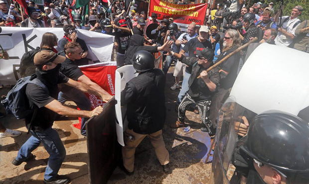 In this Saturday, Aug. 12, 2017, photo, white nationalist demonstrators clash with counter demonstr...