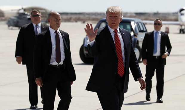 FILE - In this Tuesday, Aug. 22, 2017, file photo, President Donald Trump walks with his U.S. Secre...