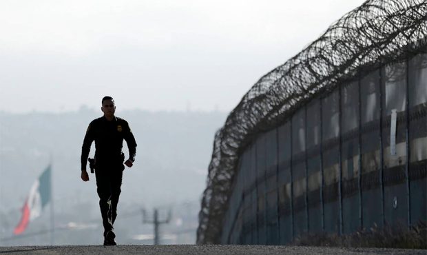 In this June 22, 2016 file photo, Border Patrol agent Eduardo Olmos walks near the secondary fence ...