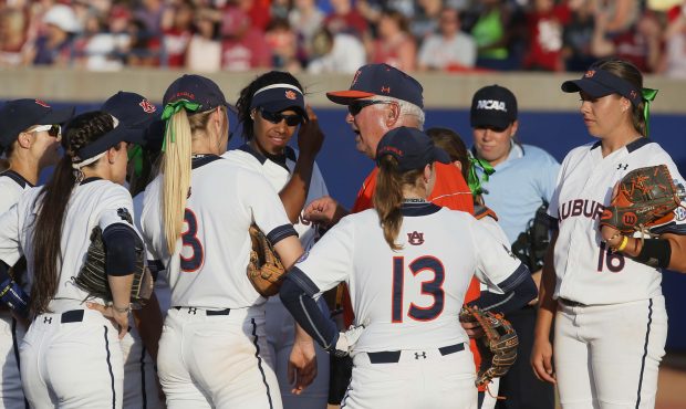 Auburn coach Clint Myers talks with his team in the pitching circle in the second inning of the sec...