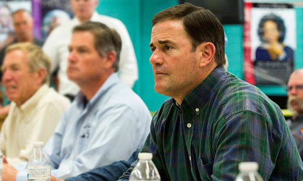 Arizona Gov. Doug Ducey listens to a briefing on a northern Arizona wildfire at a command center se...