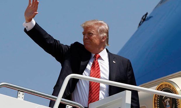 President Donald Trump waves as he boards Air Force One at Andrews Air Force Base, Md., Tuesday, Au...