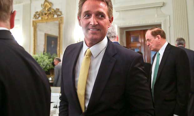 FILE - In this July 19, 2017, file photo, Sen. Jeff Flake, R-Ariz., center, walks to his seat as he...