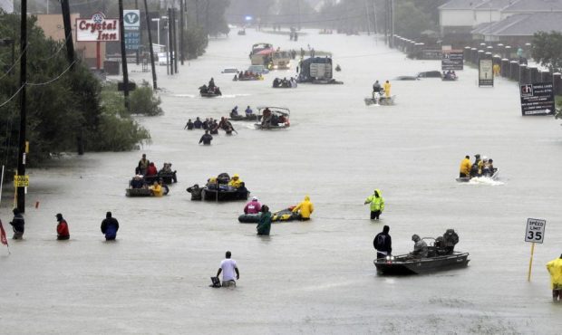 Rescue boats fill a flooded street as flood victims are evacuated as floodwaters from Tropical Stor...