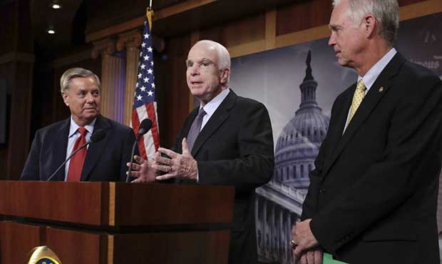 Sen. John McCain, R-Ariz., flanked by Sen. Lindsey Graham, R-S.C., left, and Sen. Ron Johnson, R-Wi...