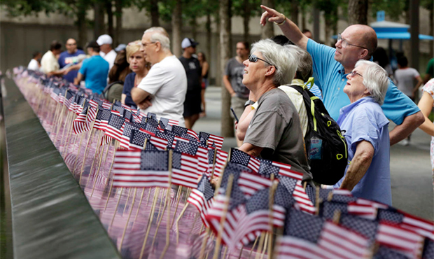 American flags were inserted in each of the 2.983 names on the borders of the reflecting pools of t...