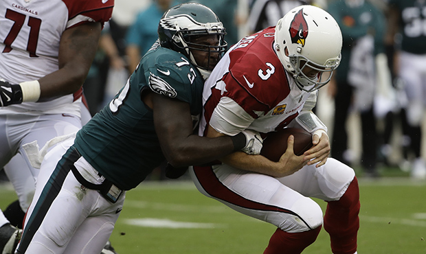 Philadelphia Eagles' Vinny Curry, left, sacks Arizona Cardinals' Carson Palmer during the first hal...