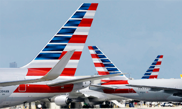 In this May 27, 2015, file photo, American Airlines jets taxi at Miami International Airport, in Mi...