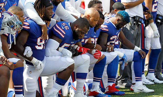 Buffalo Bills players kneel during the national anthem prior to an NFL football game against the De...