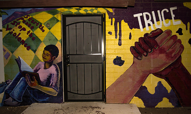 A mural on a house on 21st Street and Broadway Road represents people of color dealing with violenc...