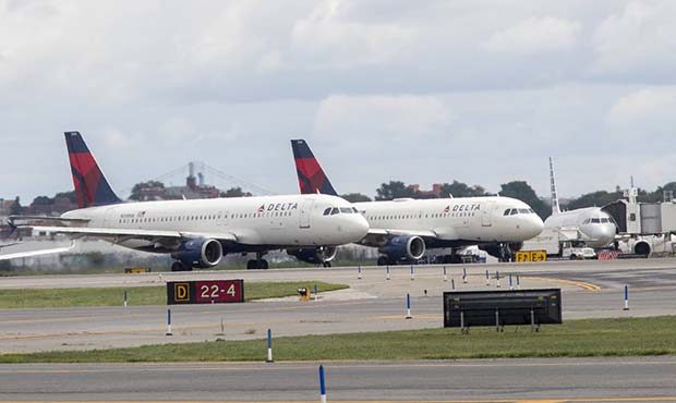 Delta Air Lines airplanes line the tarmac  ahead of a groundbreaking ceremony of the construction o...