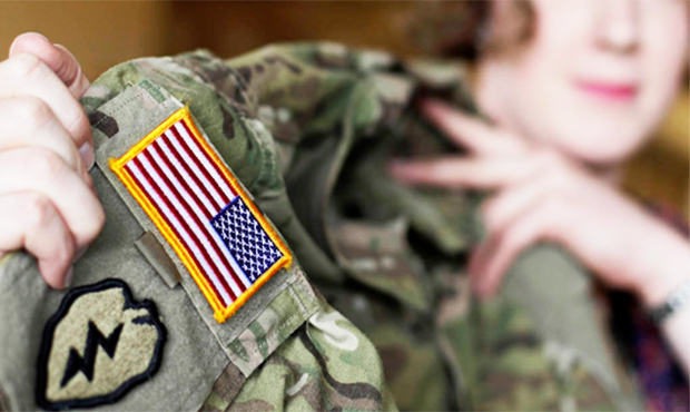 In this July 29, 2017 photo transgender U.S. army captain Jennifer Sims lifts her uniform during an...