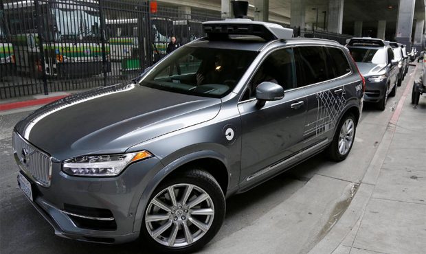 In this photo taken Tuesday, Dec. 13, 2016, an Uber driverless car heads out for a test drive in Sa...