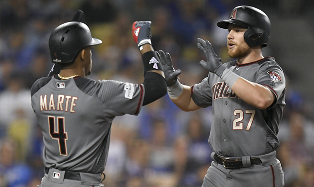 Arizona Diamondbacks' Brandon Drury, right, celebrates his three-run home run with Ketel Marte agai...