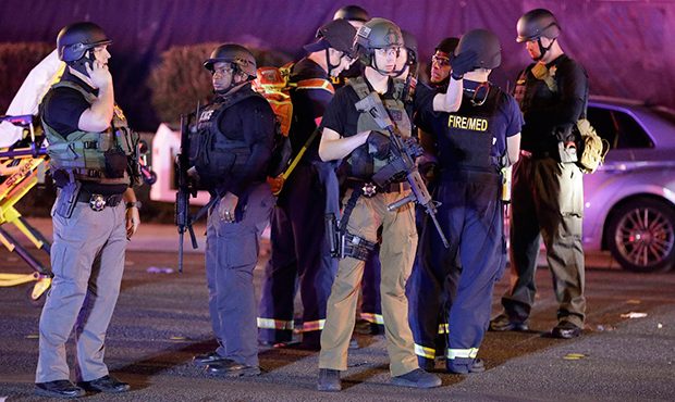 Police officers stand at the scene of a shooting near the Mandalay Bay resort and casino on the Las...