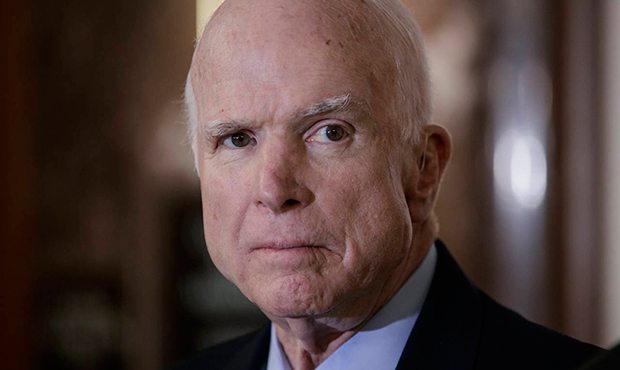 Senate Armed Services Chairman John McCain, R-Ariz., pauses before speaking to reporters during a m...