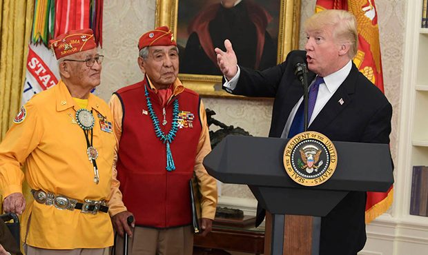 President Donald Trump, right, speaks during a meeting with Navajo Code Talkers including Fleming B...