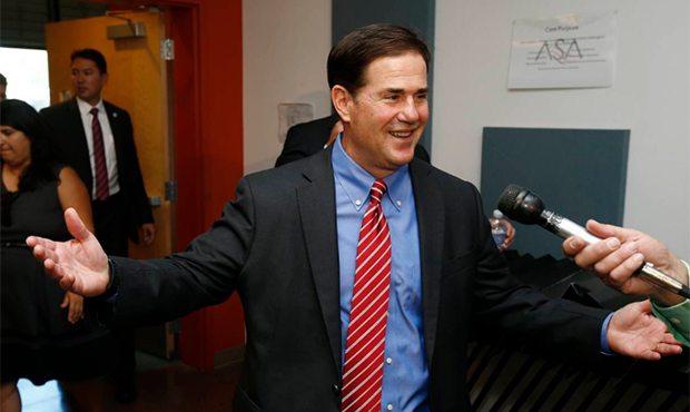 Arizona Republican Gov. Doug Ducey greets the media after touring the Arizona School for the Arts T...