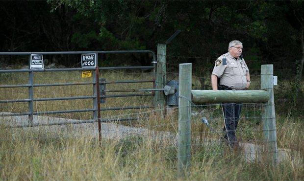 An officer guards the entrance where Devin Patrick Kelley lived Monday, Nov. 6, 2017, in New Braunf...