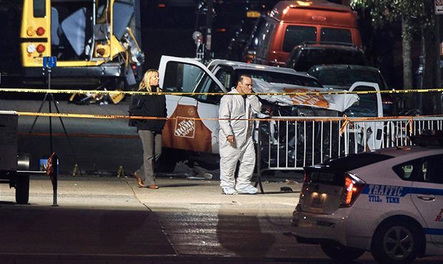 Police work near a damaged Home Depot truck after a motorist drove onto a bike path near the World ...