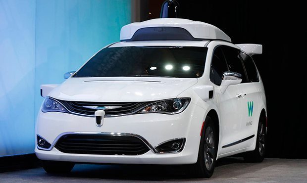 FILE - In this Sunday, Jan. 8, 2017, file photo, a Chrysler Pacifica hybrid outfitted with Waymo's ...