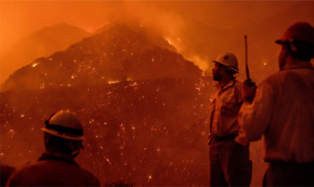 FILE - In this Dec. 8, 2017, file photo, firefighters monitor the Thomas fire as it burns through L...