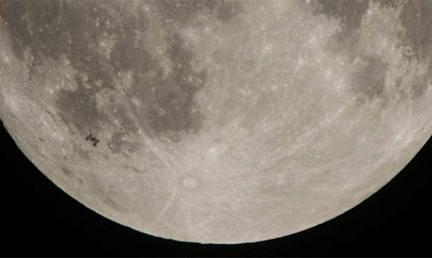 The International Space Station, with a crew of six onboard, is seen in silhouette as it transits t...
