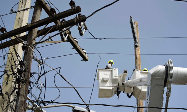 FILE - In this Oct. 19, 2017 file photo, a brigade from the Electric Power Authority repairs distri...