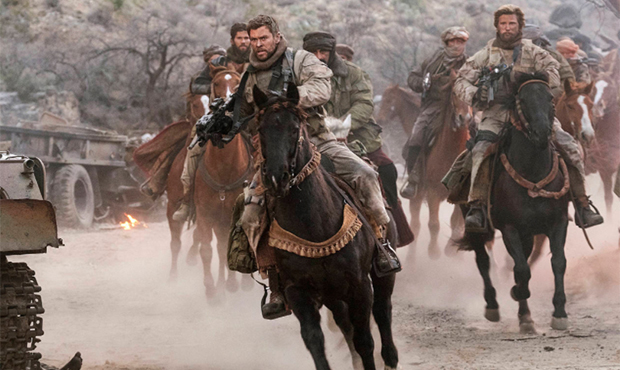 This image released by Warner Bros. Entertainment shows Chris Hemsworth, center, in a scene from "1...