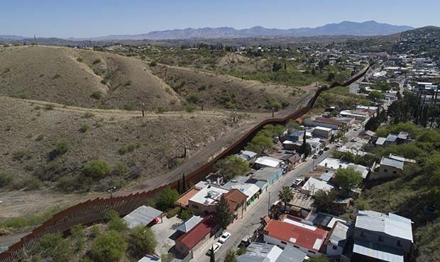 This Sunday, April 2, 2017 file photo made with a drone, shows the U.S. Mexico border fence as it c...
