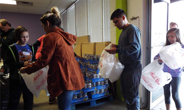 A group of volunteers work to fill backpacks for Valley schoolkids on Monday, January 15, 2018. (Tw...