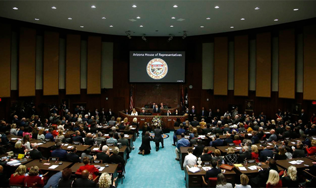 Arizona Republican Gov. Doug Ducey stands at the podium as he gives his state of the state address ...