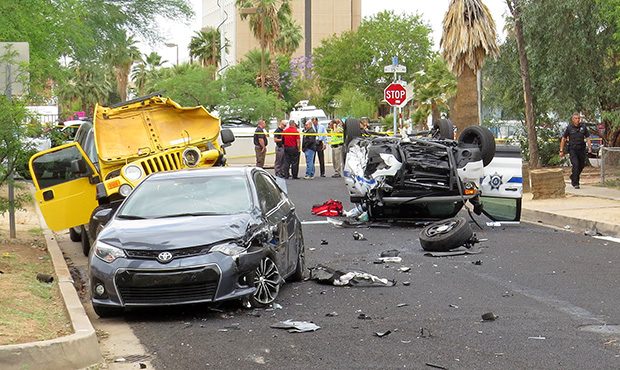 Officials stand near the wreckage after a Department of Public Safety officer and a DPS dispatcher ...