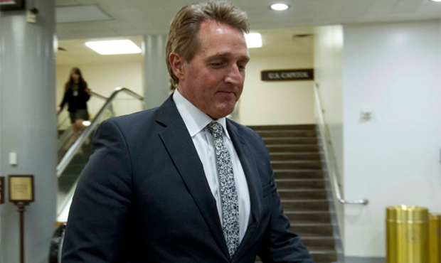 Sen. Jeff Flake, R-Ariz., walks to his office, Thursday, Feb. 8, 2018, at Capitol Hill in Washingto...