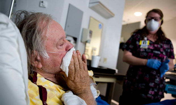 Henry Beverly, 73, battles the flu while tended to by nurse Kathleen Burks at Upson Regional Medica...