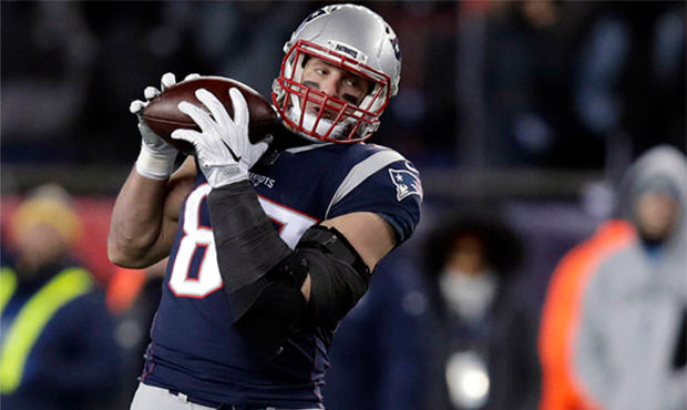 FILE - In this Jan. 13, 2018, file photo, New England Patriots tight end Rob Gronkowski, right, cat...