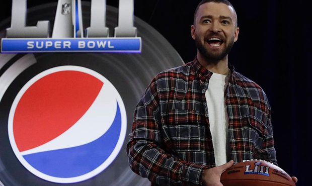 Justin Timberlake holds a football during a news conference for the NFL Super Bowl 52 football game...