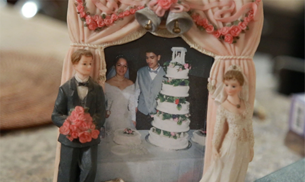 A framed photograph of Guadalupe Garcia de Rayos and her husband on their wedding day sits on the k...