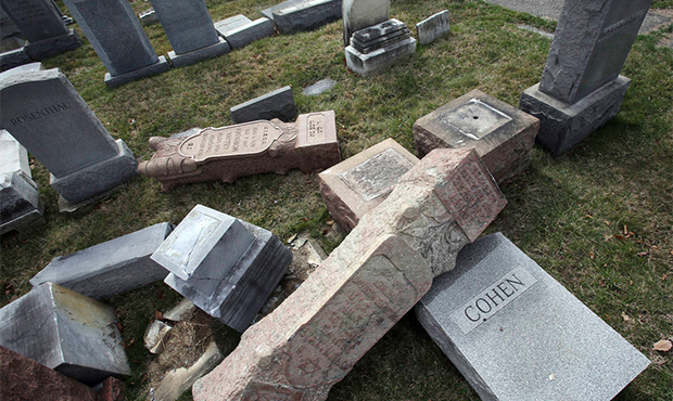 FILE - In this Feb. 27, 2017 file photo, headstones toppled and damaged by vandals lie on the groun...