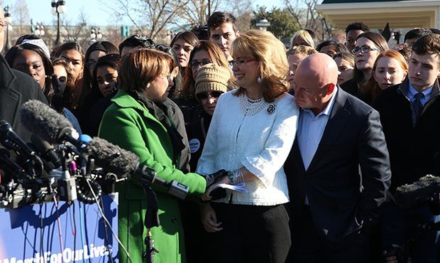 Sen. Amy Klobuchar, D-Minnesota, in green, holds hand of former Arizona Rep. Gabrielle Giffords, wh...